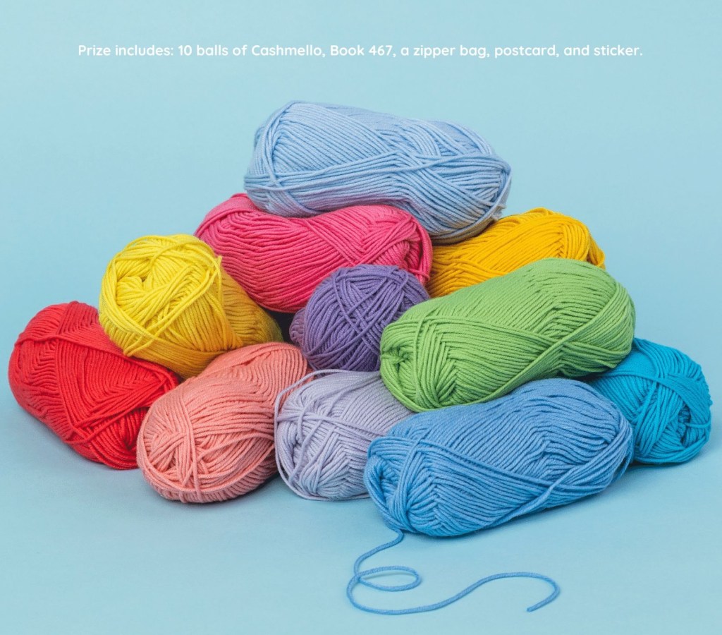 A colorful assortment of Berroco Cashmello yarn balls in various hues, including pink, blue, green, yellow, and red, arranged on a light blue background.